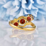 Ellibelle Jewellery Edwardian Almandine Garnet 18ct Gold Three-Stone Bypass Ring
