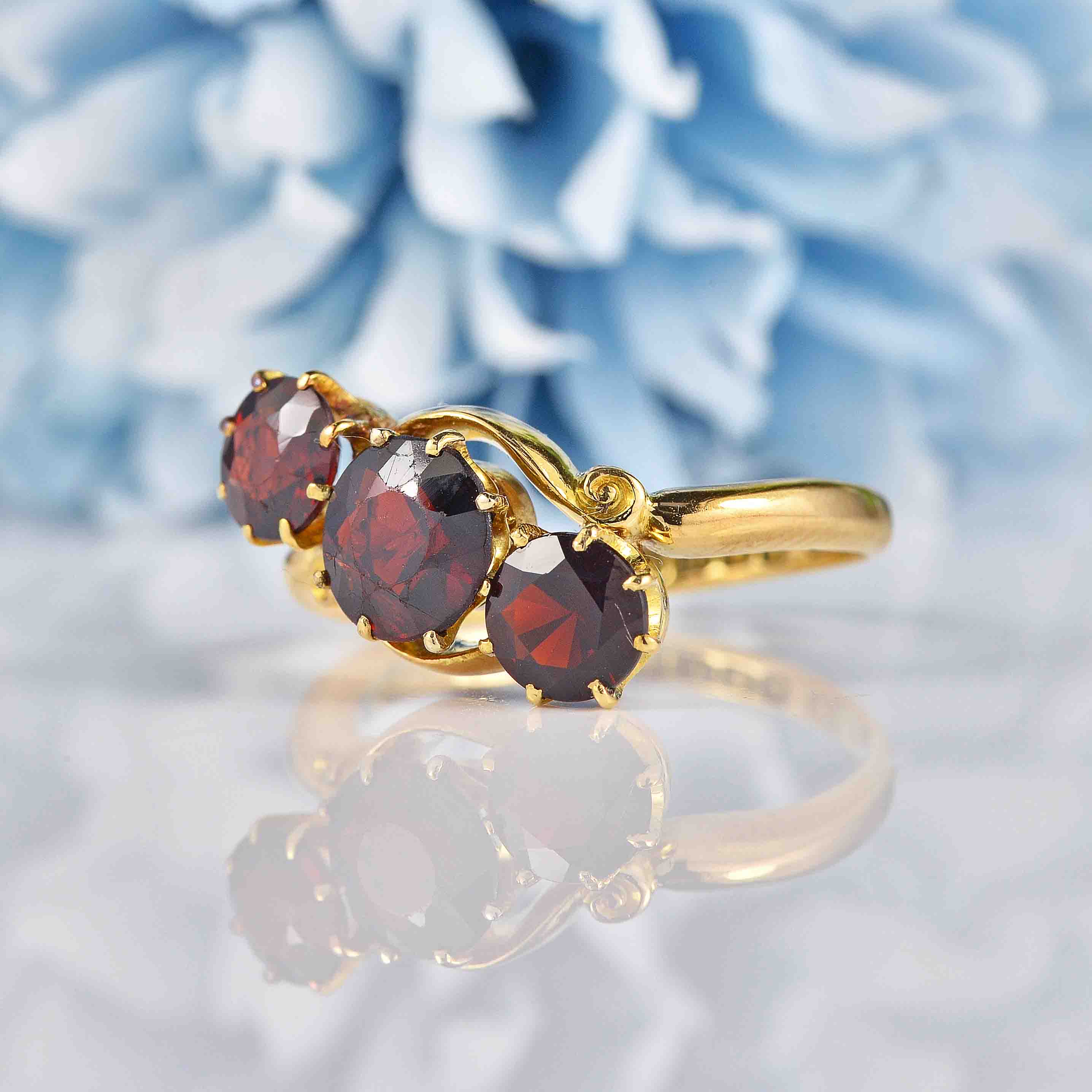 Ellibelle Jewellery Edwardian Almandine Garnet 18ct Gold Three-Stone Bypass Ring